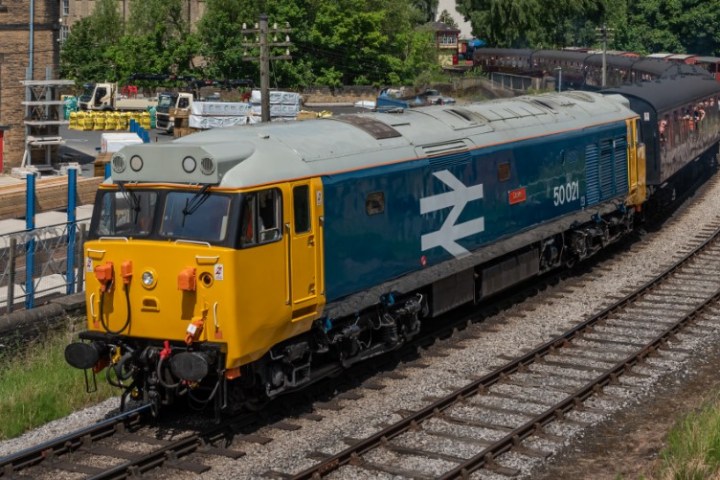 a train engine carrying carts down a track