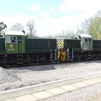 a train is parked on the side of the road
