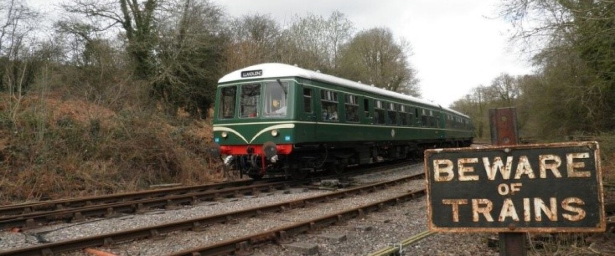 a train on a train track with trees in the background