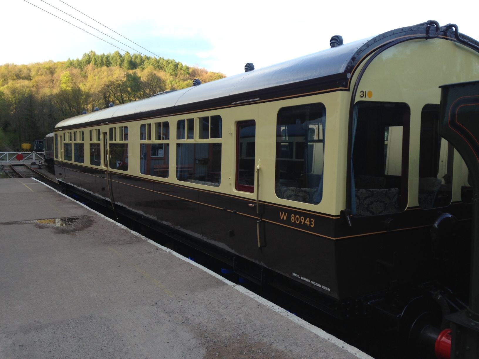 a passenger train stopped at a bus stop
