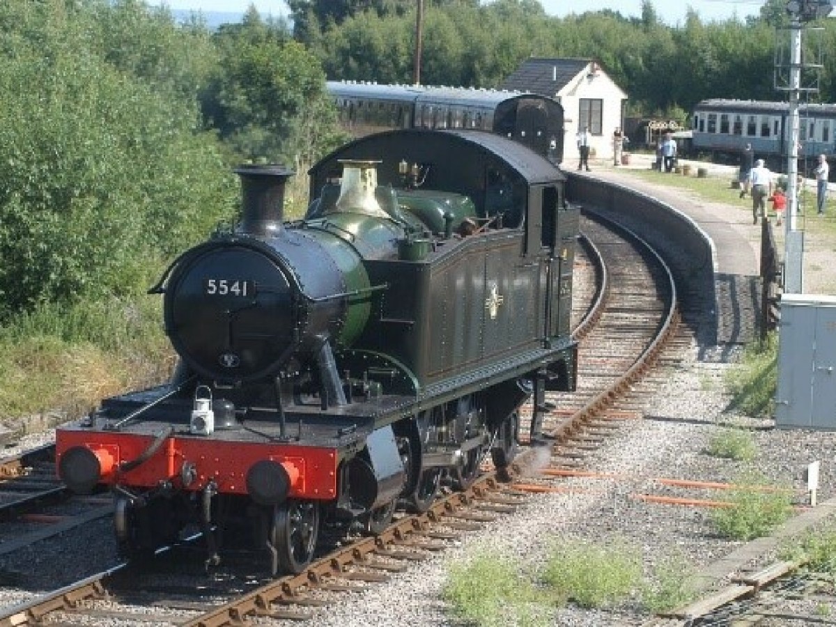 a steam engine train traveling down train tracks