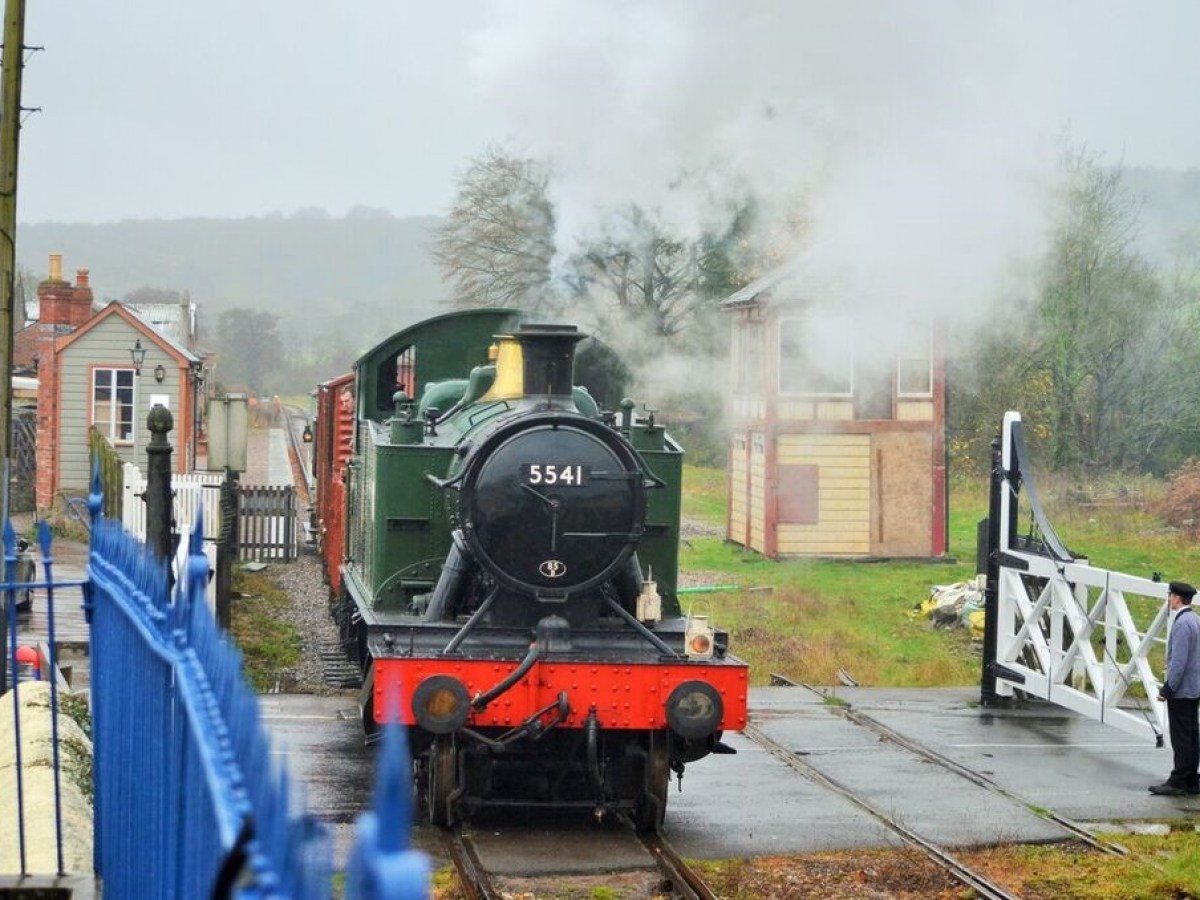 a steam train on a track with smoke coming out of it